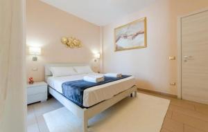 a white bedroom with a bed and a door at RossoCorallo in Gallipoli