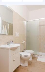 a bathroom with a toilet and a sink and a shower at RossoCorallo in Gallipoli