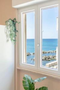 a window with a view of the ocean at RossoCorallo in Gallipoli +31 photos