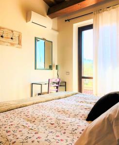 a bedroom with a bed with a table and a window at Cipressi Rossi in Greve in Chianti
