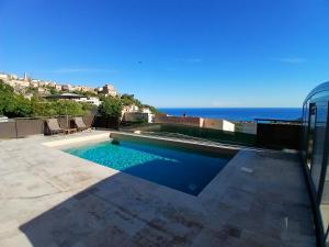 a swimming pool with the ocean in the background at Domaine La Chiusella in Monticello