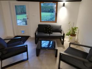 a living room with black chairs and a table at Souplex Michelet in Arras