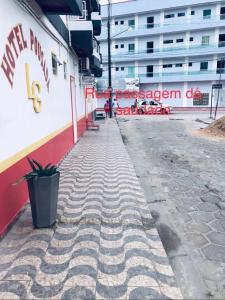 an empty sidewalk in front of a building at Hotel Pousada-LG in Breves