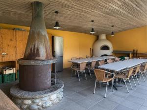 a restaurant with a brick oven in the middle of a room at Parkhotel Emmaus - Casa Rustico in Ascona