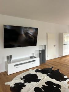 a living room with a large tv on a wall at Haus am Meer mit Sauna in Koserow in Koserow