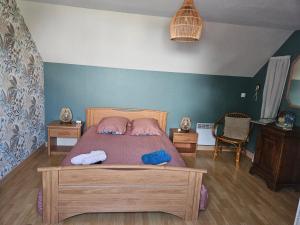 a bedroom with a bed with two towels on it at chambres évènements circuit LE MANS in La Milesse
