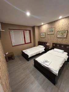 a room with two beds and a window at Апартамент за гости КРИСИ - Apartment for rent KRISI in Vidin