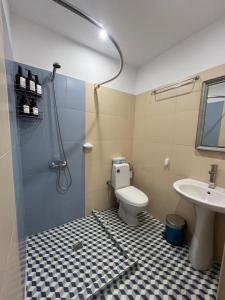 a bathroom with a shower and a toilet and a sink at Апартамент за гости КРИСИ - Apartment for rent KRISI in Vidin