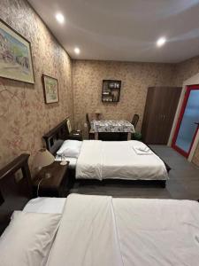 a hotel room with three beds and a table at Апартамент за гости КРИСИ - Apartment for rent KRISI in Vidin +6 photos
