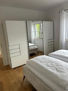 a bedroom with two beds and a large mirror at Haus am Meer mit Sauna in Koserow in Koserow