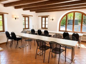 a large room with a long table and chairs at Parkhotel Emmaus - Casa Rustico in Ascona