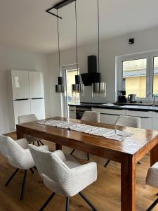 a dining room with a wooden table and chairs at Haus am Meer mit Sauna in Koserow in Koserow
