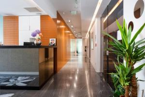 a hallway in a building with a plant at Rooms Oasis Life in Split +62 photos