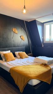 a bedroom with two beds with yellow pillows on it at Au coeur d'Harfleur 2 in Harfleur