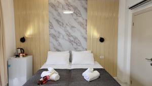 a bedroom with a bed with two stuffed animals on it at אחוזת מונפלייר in Tiberias