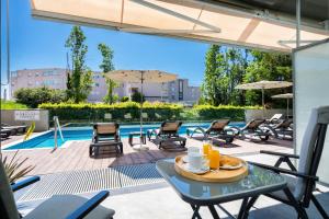 a patio with a table and chairs and a pool at Rooms Oasis Life in Split