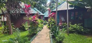 a path in a garden next to a building at Kizumba House in Arusha
