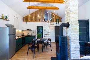 a kitchen with a stove and a table with chairs at Crossroads Hideaway in Brod na Kupi