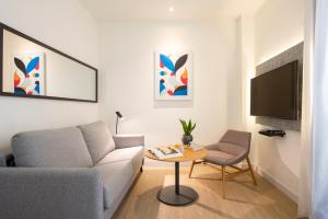 a living room with a couch and a table at INNSiDE by Meliá Madrid Gran Vía in Madrid