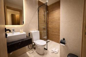 a bathroom with a toilet and a sink and a shower at Cairo Stays Hotel in Cairo +28 photos