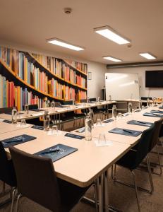 a classroom with tables and chairs in a library at Campanile Rennes Centre - Gare in Rennes