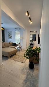a living room with a couch and a table at Apartament Luna in Şelimbăr