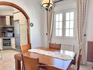 a kitchen and dining room with a table and a mirror at Chalet Sobre do Valo in Sanxenxo +12 photos
