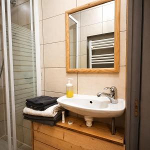 a bathroom with a sink and a mirror at Logicoeur in Gérardmer