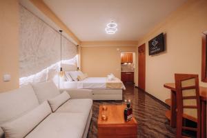 a living room with a couch and a bed at Villa Dislievski in Ohrid