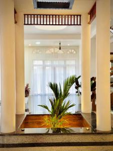 a lobby with a plant in the middle of a building at Kings Castle in Varkala +63 photos