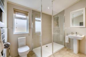 a bathroom with a shower and a toilet and a sink at Primrose 1 bed-No Pets-Lily in Eye +12 photos