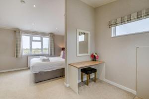 a bedroom with a bed and a table and a mirror at Primrose 1 bed-No Pets-Lily in Eye