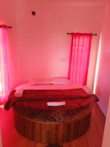 a bed in a room with pink lights at Wander homes in Ooty +17 photos