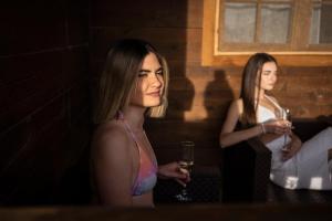 two women standing in a room with a glass of wine at Cabaña con jacuzzi privado in Caravaca de la Cruz +2 photos