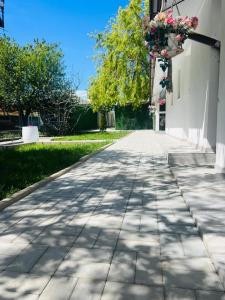 a sidewalk in front of a building with flowers on it at Mafmaf Tiny Houses - încasare cu card de vacanță in Mamaia Sat/Năvodari +27 photos