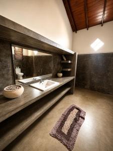 a bathroom with a sink and a mirror at Kabalana Surf Hostel in Ahangama +42 photos