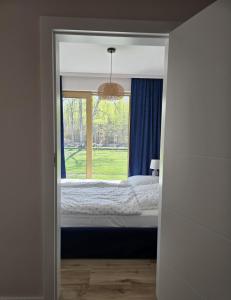 a bedroom with a bed and a window at Apartamenty Miku - Łeba in Żarnowska +24 photos