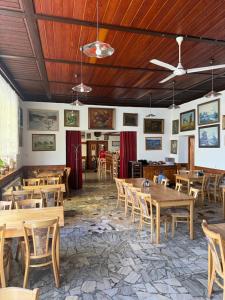 a dining room with wooden tables and chairs at Hotel Chata ve Volarech Šumava in Volary