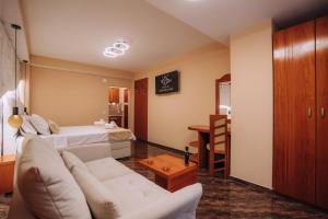 a living room with a couch and a bed at Villa Dislievski in Ohrid