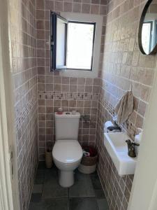 a bathroom with a toilet and a sink at Maison Erbalunga in Brando +8 photos