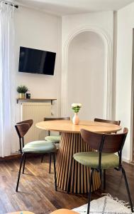 a dining room with a wooden table and chairs at L'Escapade Mussipontaine in Pont-à-Mousson