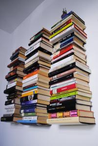 a stack of books stacked on top of each other at Festina Lente B&B in Porto Recanati