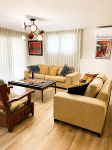 a living room with two couches and a coffee table at Poly's Villa Lefkada in Lefkada