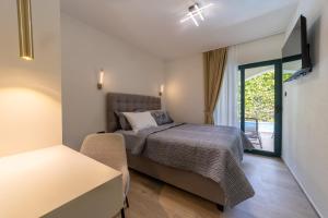 a bedroom with a bed and a sliding glass door at Klaris Guest house in Budva +83 photos
