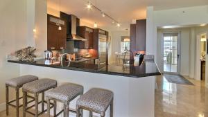 a kitchen with a counter and stools in a room at 311 Mariners Club in Key Largo