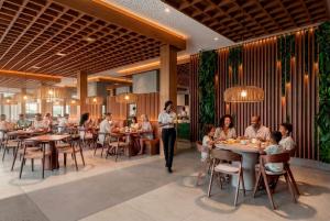 a group of people sitting at tables in a restaurant at ROBINSON BOA VISTA - All inclusive in Sal Rei