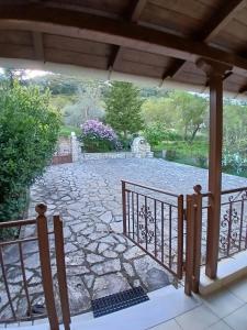 a view of a stone patio from a porch at Menelais Guesthouse in Khotoússa