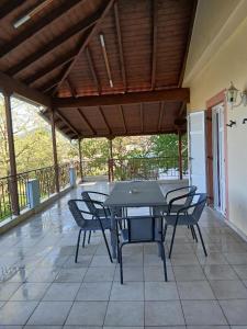 a black table and chairs on a patio at Menelais Guesthouse in Khotoússa