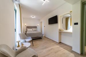 a living room with two chairs and a couch at Klaris Guest house in Budva