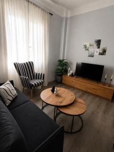 a living room with a couch and a table at Helena's house in Ermoupoli